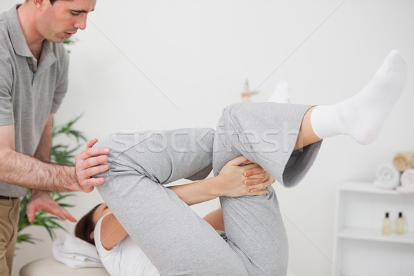 Woman doing her exercise while being helped in a room Stock photo © wavebreak_media