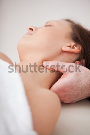 Close-up of doctor pressing his thumb on the neck of his patient indoors Stock photo © wavebreak_media