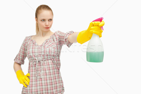 Serious woman holding a spray bottle while looking away Stock photo © wavebreak_media
