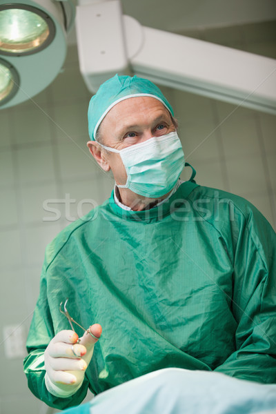 Smiling scissors holding scissors in a surgical room Stock photo © wavebreak_media