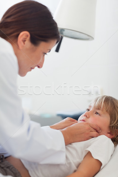 Stock photo: Doctor auscultating a child in hospital ward