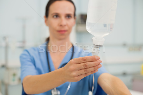 Nurse adjusting drip in hospital room Stock photo © wavebreak_media
