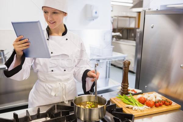 Female chef using tablet pc while cooking a soup Stock photo © wavebreak_media