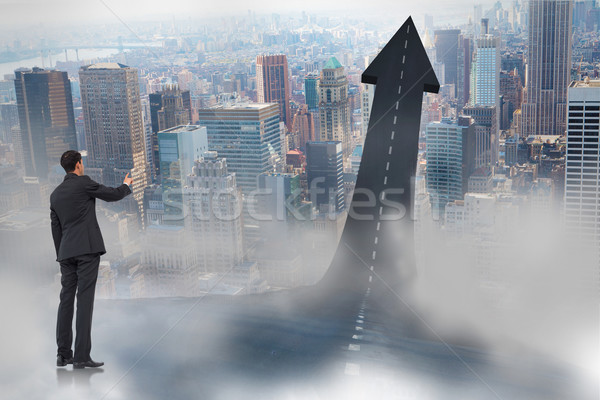 Composite image of asian businessman pointing Stock photo © wavebreak_media