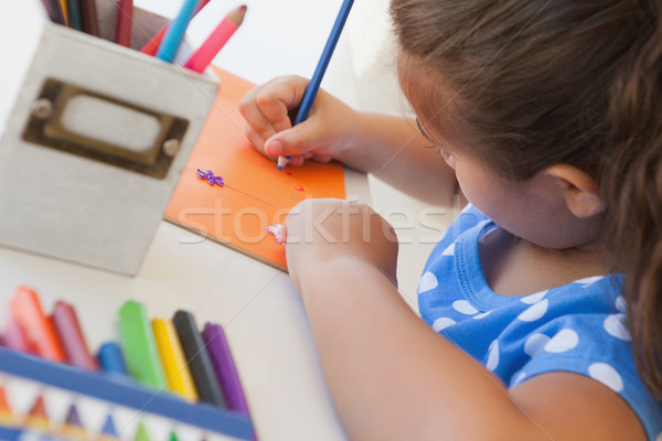 Close-up of a girl drawing on orange paper Stock photo © wavebreak_media