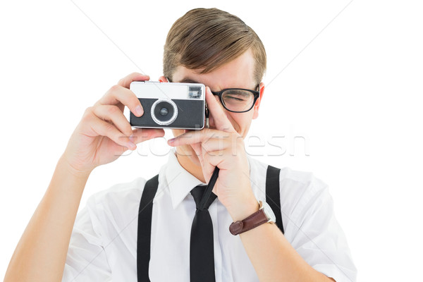 Stock photo: Geeky hipster holding a retro camera
