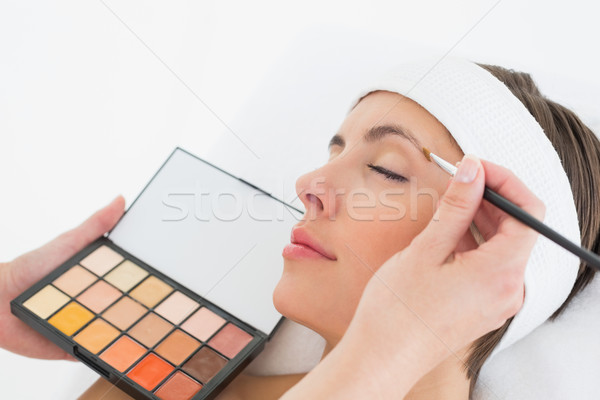 Hand applying eyeshadow to beautiful woman Stock photo © wavebreak_media