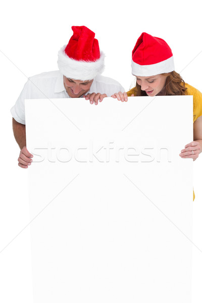 Festive couple showing a poster Stock photo © wavebreak_media