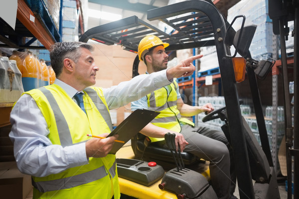 Forklift driver talking with his manager Stock photo © wavebreak_media