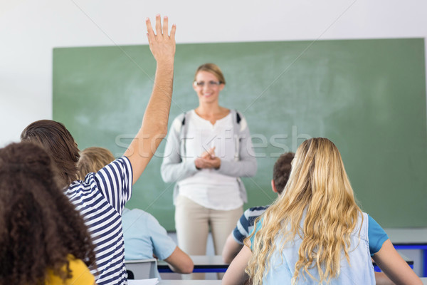 Student raising hand in classroom Stock photo © wavebreak_media