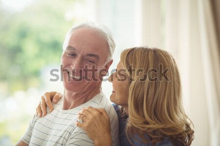 Smiling couple petting their gringer cat on the couch Stock photo © wavebreak_media