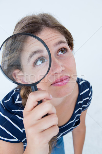 Woman holding magnifying glass Stock photo © wavebreak_media