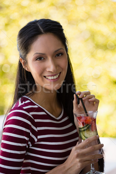 Portrait of young woman holding cocktail Stock photo © wavebreak_media