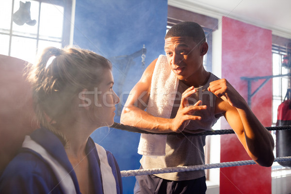 Trainer assisting woman in boxing Stock photo © wavebreak_media