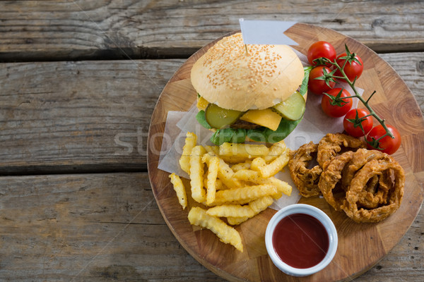 Overhead view of burger and fries with onion rings by sauce Stock photo © wavebreak_media