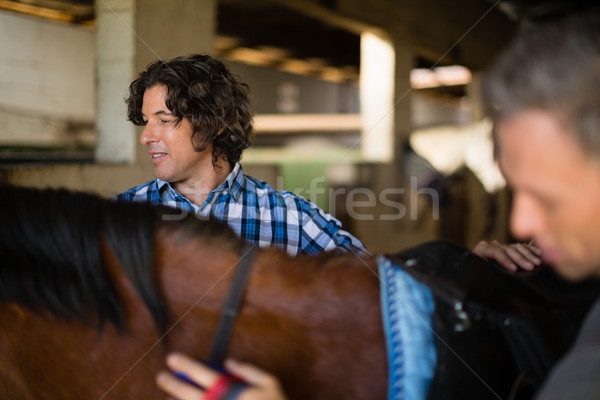 Man grooming the horse in the stable Stock photo © wavebreak_media