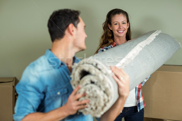 Happy couple carrying rolled up rug Stock photo © wavebreak_media