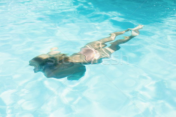 Gyönyörű nő úszik úszómedence napos idő fürdő női Stock fotó © wavebreak_media
