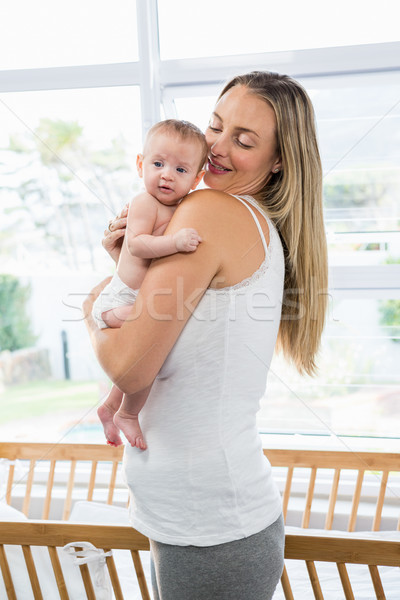 Mother carrying her baby in living room Stock photo © wavebreak_media
