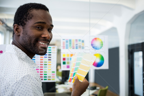 Graphic designer holding color swatch Stock photo © wavebreak_media