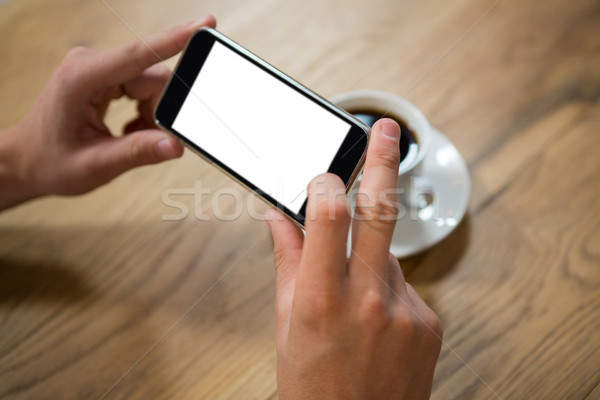Man hands photographing coffee through smartphone in cafe Stock photo © wavebreak_media