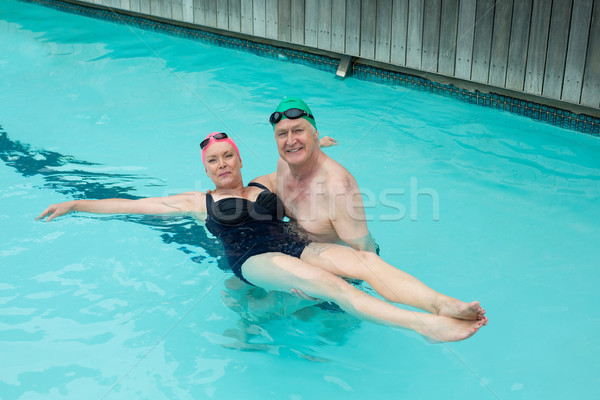Loving mature couple enjoying in swimming pool Stock photo © wavebreak_media