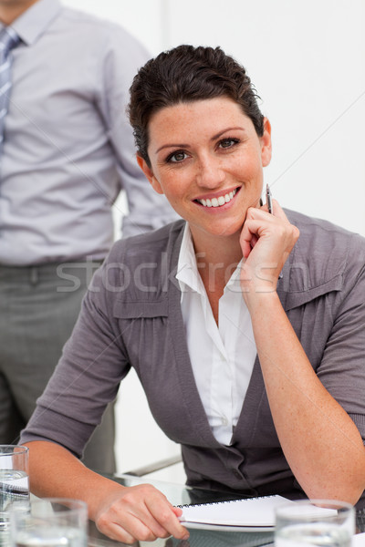 Smiling confident businesswoman taking notes  Stock photo © wavebreak_media