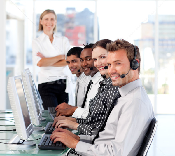 Stock photo: Portrait of a Relaxed manager leading her representative team in a office