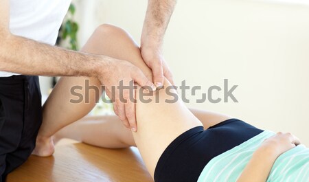 Young physical therapist giving a leg massage Stock photo © wavebreak_media