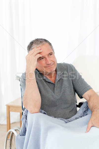 Senior in his wheelchair having a headache at home Stock photo © wavebreak_media