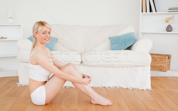 Beautiful female in underwear posing while sitting on the floor in the living rom Stock photo © wavebreak_media