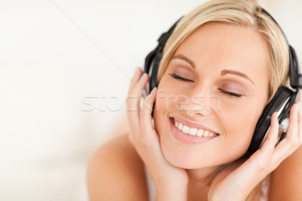 Közelkép derűs nő visel fejhallgató hálószoba Stock fotó © wavebreak_media