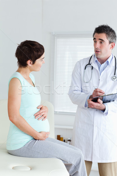 Sitting Pregnant woman talking to her doctor in a room Stock photo © wavebreak_media
