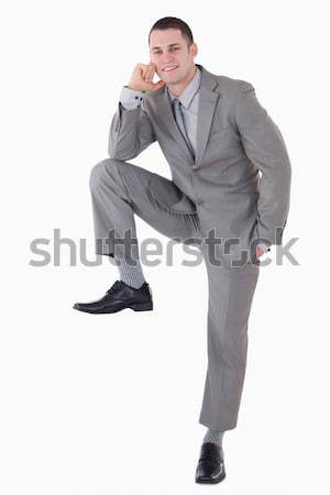 Portrait of a businessman with his foot on something against a white background Stock photo © wavebreak_media