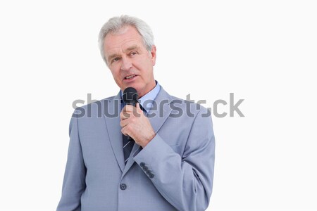 Mature tradesman using microphone against a white background Stock photo © wavebreak_media