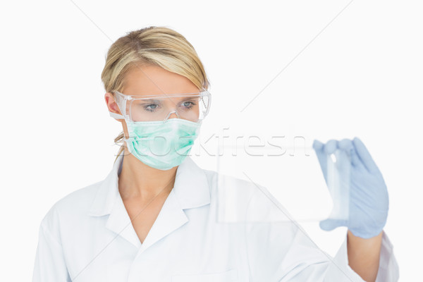 Female surgeon analysing clear pane  Stock photo © wavebreak_media