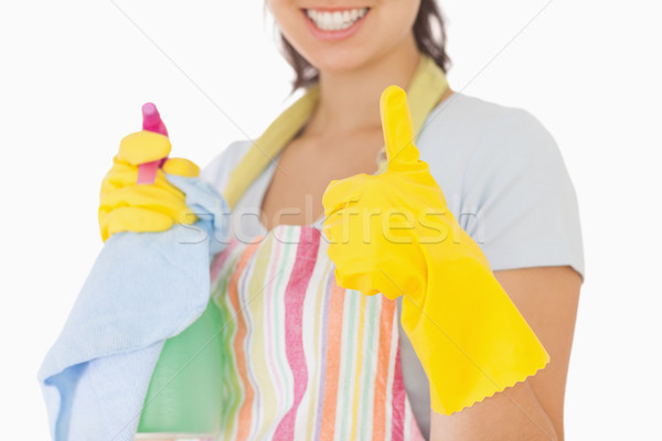 Woman giving thumbs up in rubber gloves holding cleaning products Stock photo © wavebreak_media