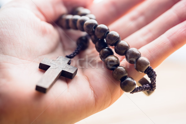 Hand holding wooden rosary beads Stock photo © wavebreak_media