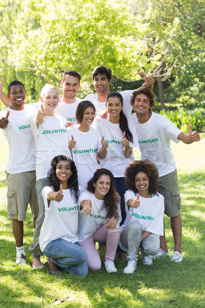 Stock photo: Volunteers showing thumbs up in park