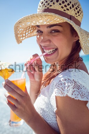 Woman sitting on the beach applying suncream Stock photo © wavebreak_media