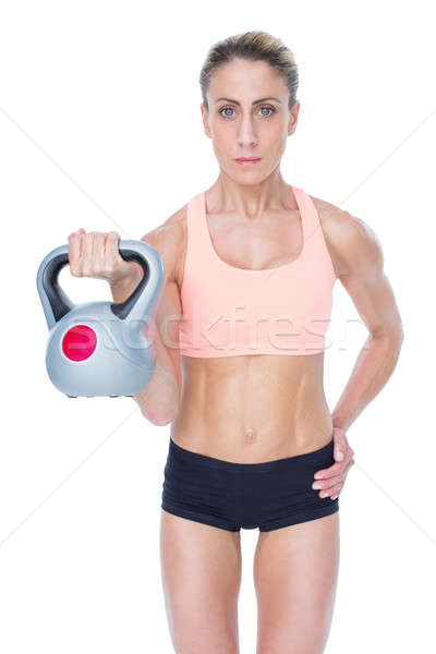 Serious female crossfitter lifting kettlebell  Stock photo © wavebreak_media