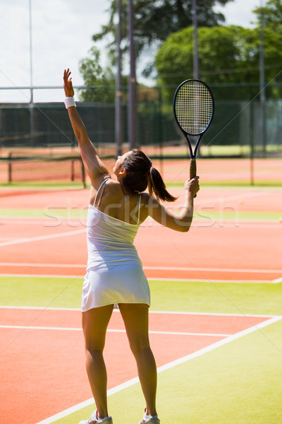 Stock photo: Pretty tennis player about to serve