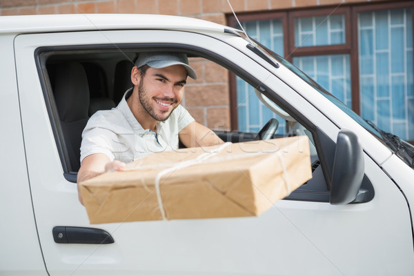 Delivery driver offering parcel from his van Stock photo © wavebreak_media