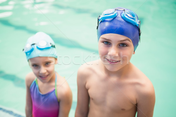 Cute little siblings standing poolside Stock photo © wavebreak_media