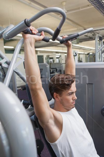 Fit man using weights machine for arms Stock photo © wavebreak_media