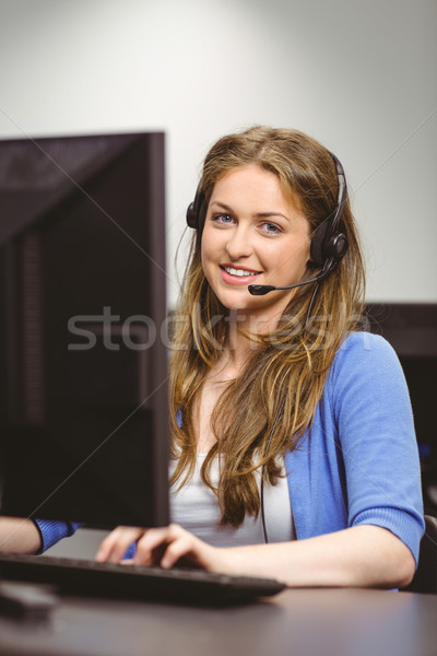 Student sitting at the computer room wearing headset Stock photo © wavebreak_media