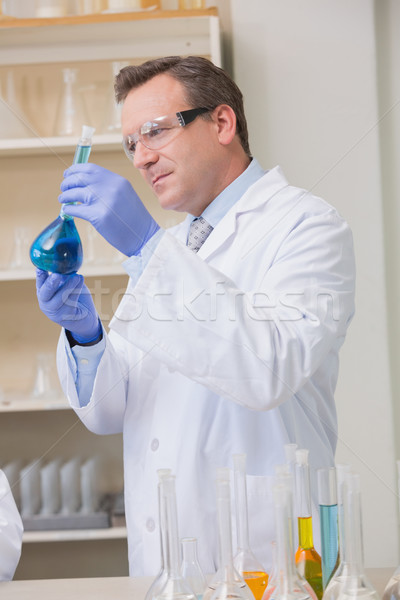 Scientist examining blue precipitate in baker  Stock photo © wavebreak_media