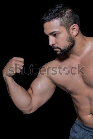 Strong bodybuilder flexing his bicep Stock photo © wavebreak_media