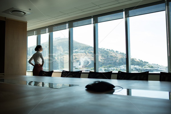 Businesswoman looking through window in conference room Stock photo © wavebreak_media