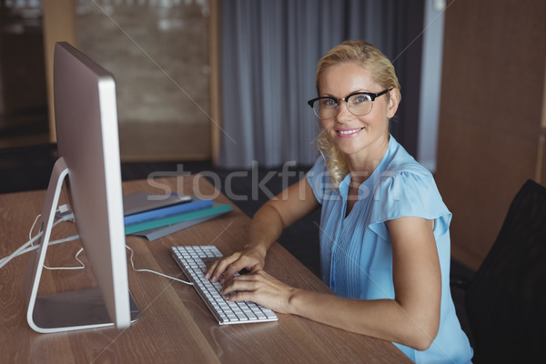 Portrait of smiling executive working at desk Stock photo © wavebreak_media